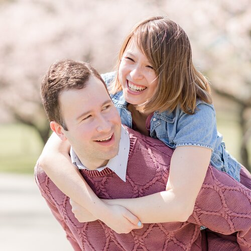 Nick carrying Julia on his back, both laughing