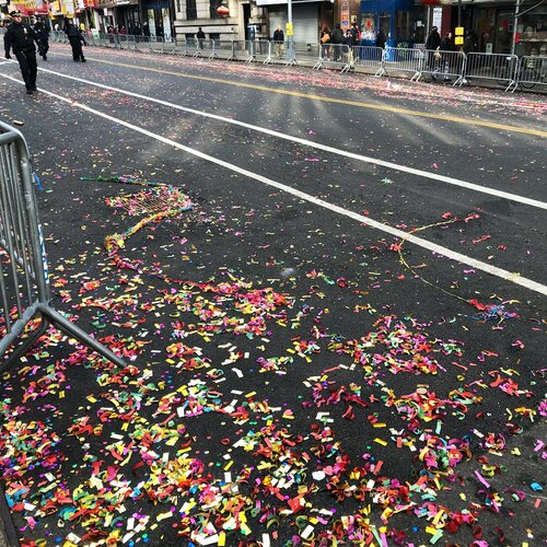 Confetti speckling the street after the Lunar New Year Parade